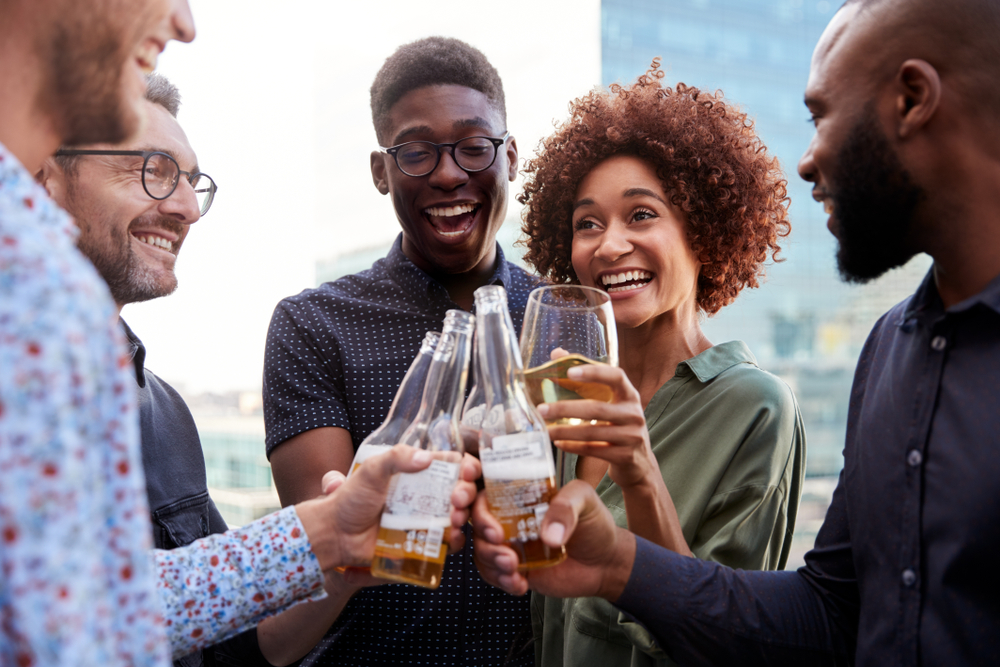 group of 30 year-olds toasting and drinking beer